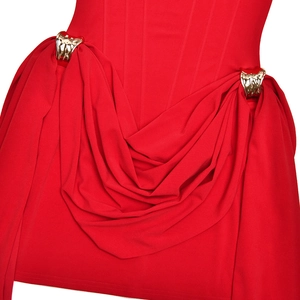 Detailed close-up of red bodycon dress featuring gold metal buckles and waist pleats