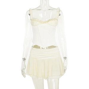 Detailed view of the layered ruffle hem and pleated corset design on the beige summer set