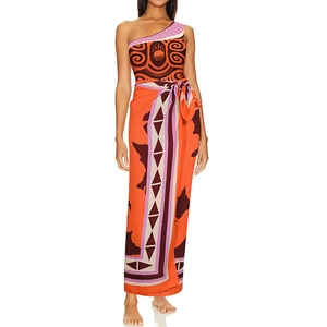 Detail of one-shoulder tribal print swimsuit and matching sarong with sun patterns