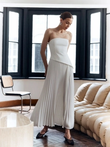 Elegante completo bianco a due pezzi con top a fascia plissettato e gonna lunga da donna