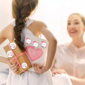 Detail of Happy Mother's Day floral stickers on a gift box in a warm family setting