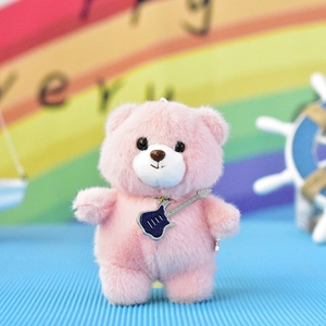 Detailed view of a cute pink plush teddy bear keychain pendant with a guitar accessory.