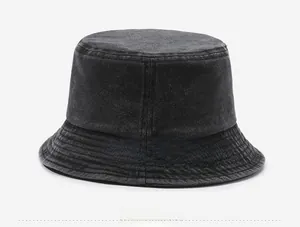 Detail view of washed denim bucket hat featuring metal eyelets and reinforced stitching