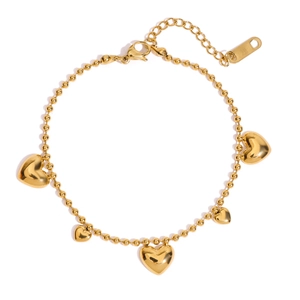 Detail of 18k gold bead bracelet featuring five solid heart charms and lobster clasp
