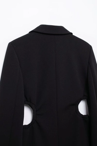 Detail of black waist cutout blazer showing the pleated edges and back tailoring design