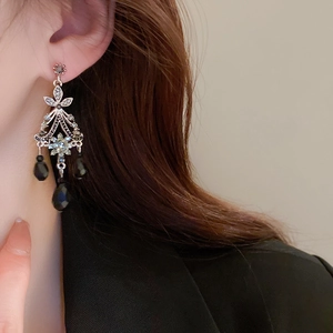 Vintage Baroque drop earrings with black crystals and silver tassels on a female model