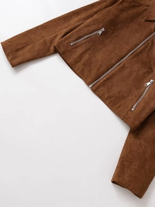 Close-up of brown suede jacket detailing the lapel collar and metal zipper pocket
