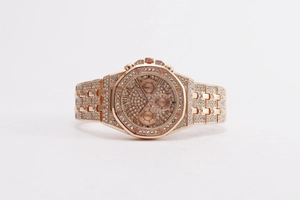 Detail of rose gold luxury watch with full crystal pavé, Roman numerals and three-dial face
