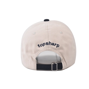 Detail of beige cotton baseball cap with topsharp embroidery and metal adjustment buckle