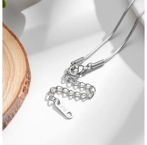 Close-up of lobster clasp and snake chain with K14 engraving on adjustable silver necklace