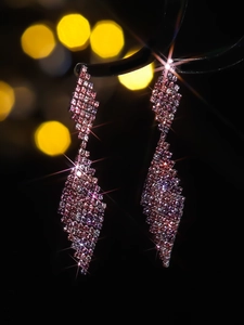 Detailed view of luxury rose pink long tassel earrings with sparkling rhinestones