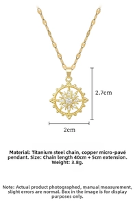 Detail view of gold sunburst pendant showing 2cm width and 2.7cm height measurements