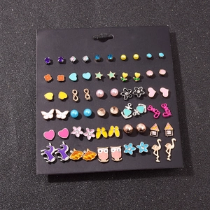 30 pairs of colorful animal and heart stud earrings set on a black display card