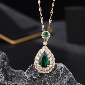 Gold titanium steel necklace featuring a pear-shaped emerald pendant with zircon accents