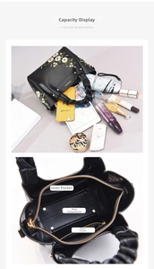 Detailed interior of the embroidered leather handbag showing main pockets and storage capacity