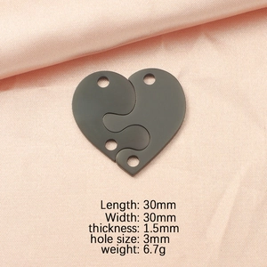 Detailed view of 30mm interlocking heart puzzle pendant in mirror finish titanium steel