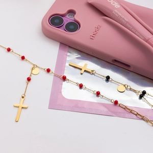 Detailed flat lay of 18K gold stainless steel cross necklace with black and red beads