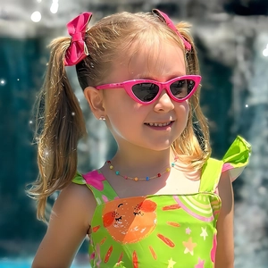 Pink cat-eye kids sunglasses with bow clips and smiling sun swimsuit for summer