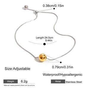 Detail view of adjustable stainless steel bracelet with golden bead and sizing dimensions