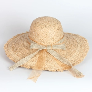 Wide brim raffia sun hat with bow decoration and frayed edges for beach wear