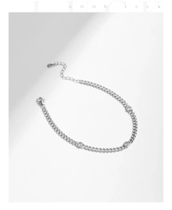 Detailed macro of 925 sterling silver curb chain bracelet with lobster clasp and round zircons