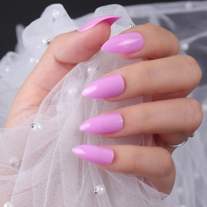 Glossy pink purple almond press-on nails shown on hand with elegant lace background