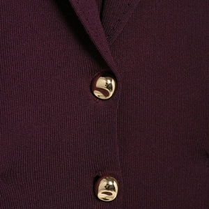 Elegant sleeveless knit top in burgundy with decorative gold buttons and waist fit