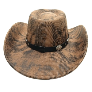 Detail of western cowboy hat showing vintage brown felt texture and silver metal conchos