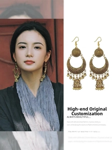 Detailed view of vintage gold hollow circular earrings with bohemian fringe tassels