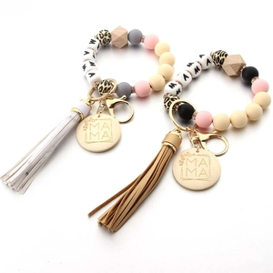 Silicone and wood bead MAMA wristlet keychain with leather tassels and gold accents