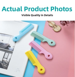 Macro shot of colorful plastic baby combs with heart-shaped handles in a 4-pack set
