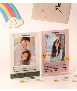 Macro shot of 3-inch acrylic photo frames with Instagram UI and emoji sticker decorations