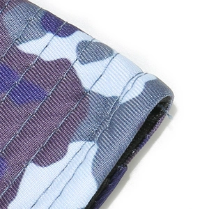 Close-up of camouflage bucket hat fabric with purple, blue, and gray quilted stitching