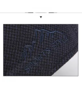 Detail view of waffle knit fabric and mountain embroidery with Sports Style text