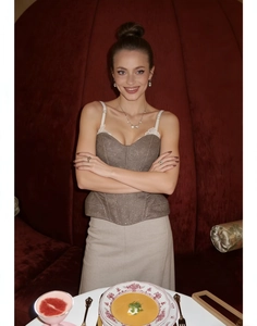 Detail of coffee-brown corset top with shimmer texture and elegant boning structure