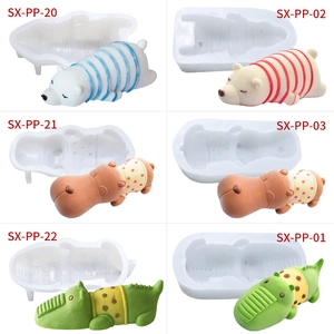 Detail view of polar bear, hippo, and crocodile silicone molds with finished crafts
