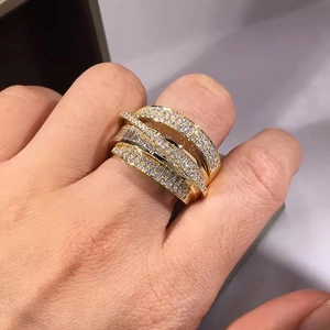 Detailed close-up of multi-layer gold plated ring with micro-pave zircon and baguette crystals