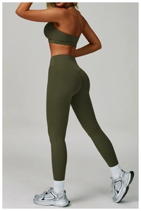 Detail view of olive green yoga set featuring backless sports bra and high waist leggings
