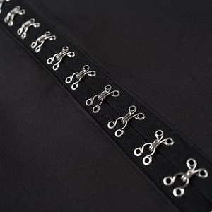Detail of metal hook-and-eye closures and stitching on black sleeveless top