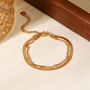 Close-up of golden double-layer chain with lobster clasp and adjustable extension detail