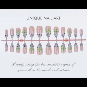 Detailed set of 24 almond press-on nails featuring zebra stripes and green clover charms
