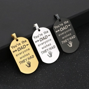 Detailed view of laser-engraved military dog tags in gold, silver, and black stainless steel