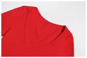 Detail of red sports top featuring a deep V-neckline and high-quality stitching