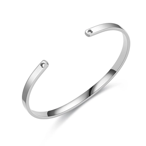 Detailed view of silver stainless steel C-shaped cuff bracelet with heart cutouts
