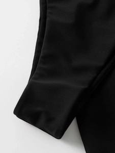 Detail of premium black bikini fabric featuring smooth texture and precise stitching detail