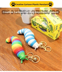 Macro view of flexible rainbow and blue finger slug keychains on dark wood surface