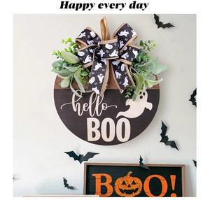 Detail of wooden Halloween door sign with hello BOO text, ghosts, and large ribbon bow