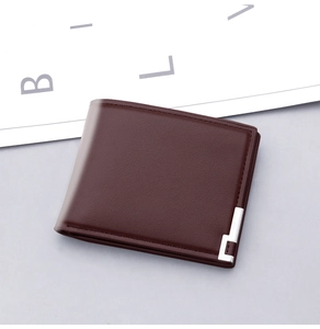Detail of burgundy leather wallet texture with silver L-shaped metal trim decoration
