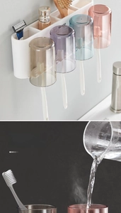 Detail showing hot water being poured into heat-resistant cups on a wall-mounted rack