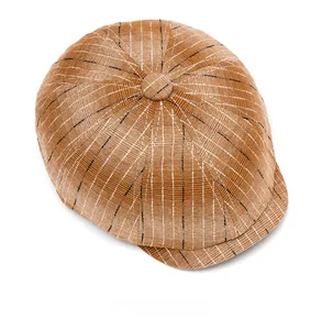 Top view of brown plaid newsboy cap with textured stitching and center button detail